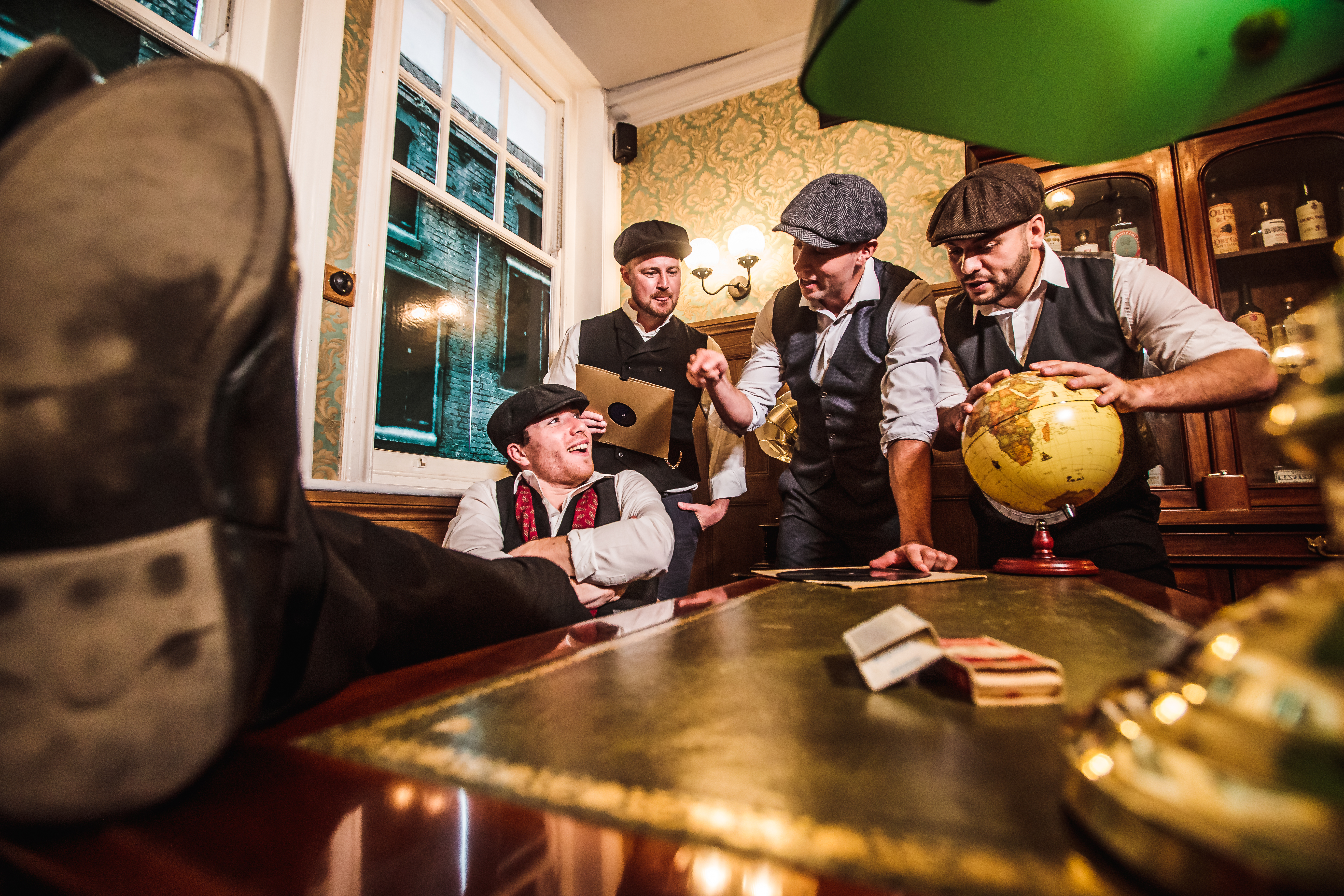 Group of men in flat caps in Peaky Blinders-themed escape room