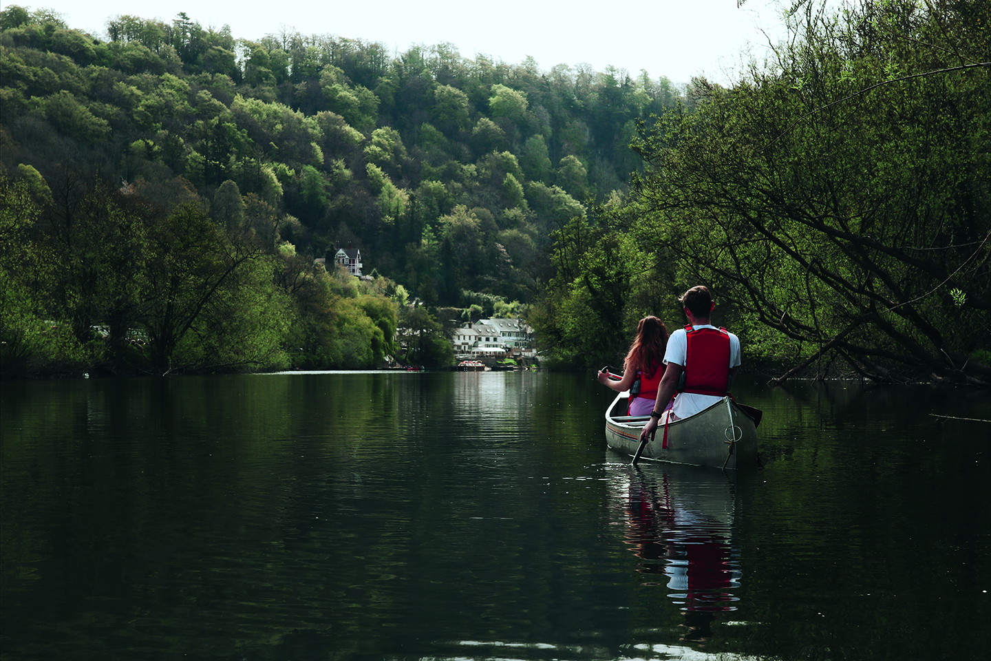 Two people canoeing on the River Wye