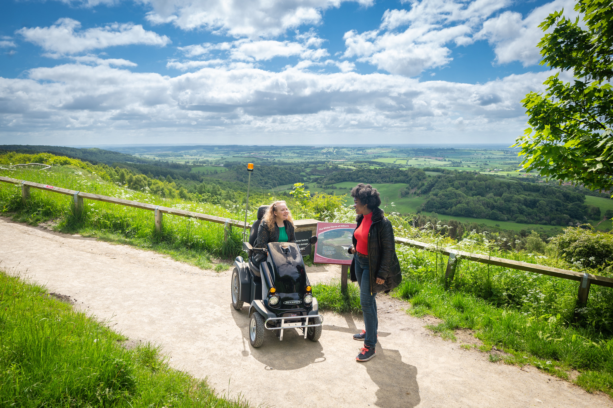 Two women on the White Horse Trail, one using a tramper