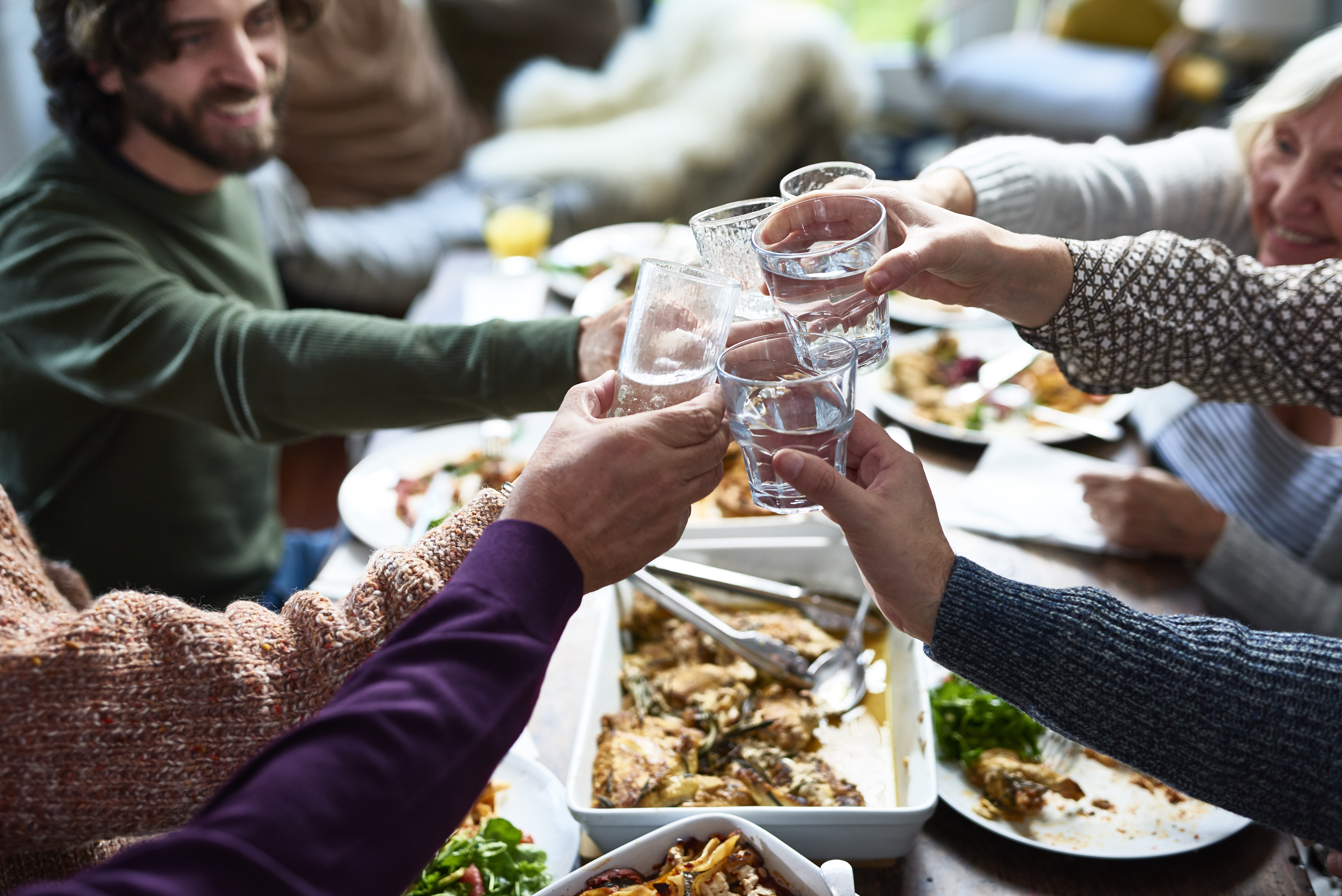 A group of people or relatives tasting drinks at a lunch