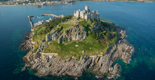 St Michaels Mount, a historic fortified building on a rocky outcrop in the Marazion bay, off the coast of Cornwall. Aerial view.