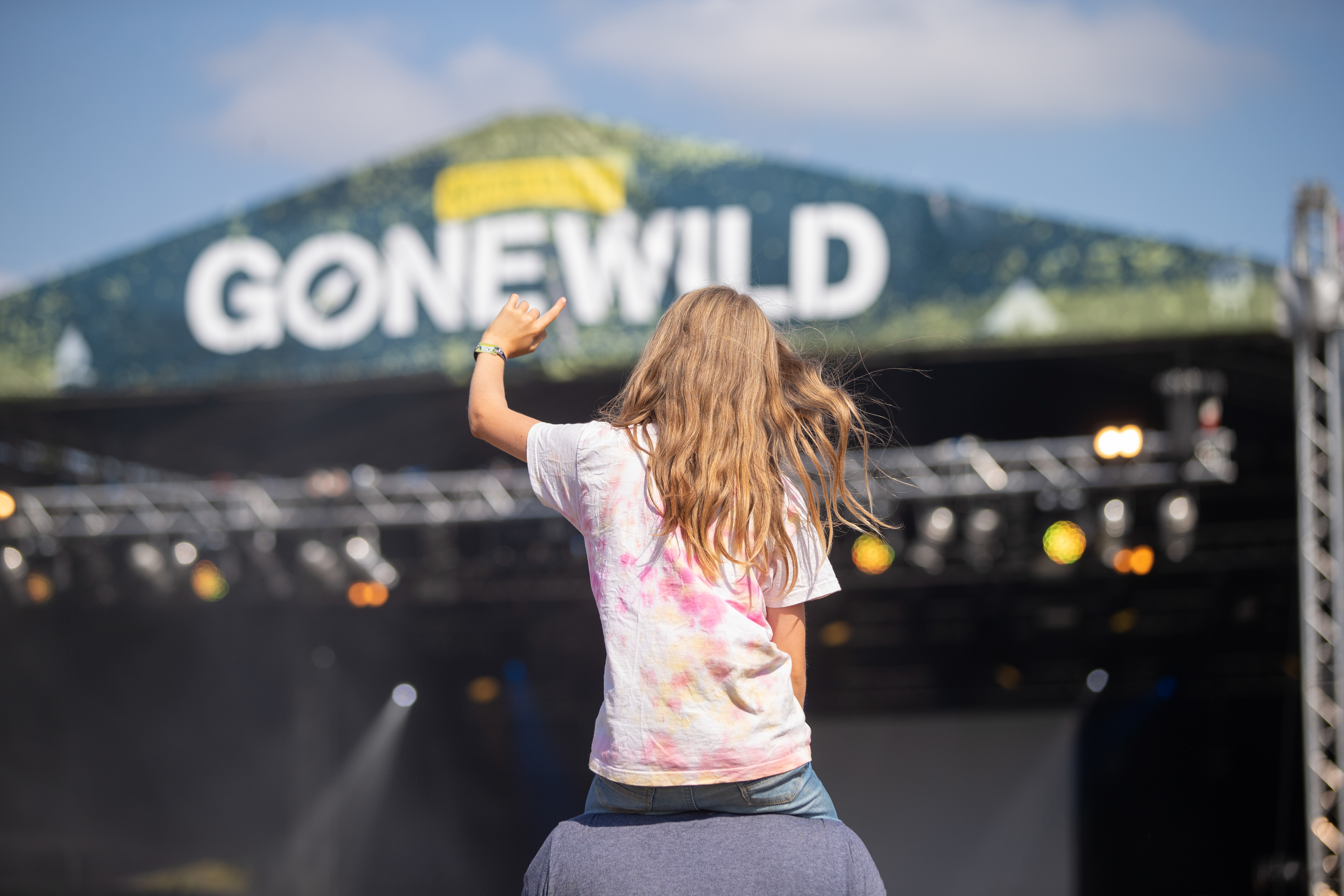 Girl sitting on man's shoulders at Gone Wild Festival