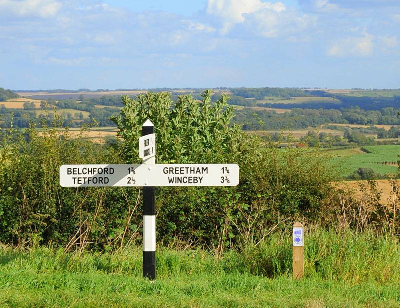 A signpost stands in front of the sprawling green vistas of the Lincolnshire Wolds
