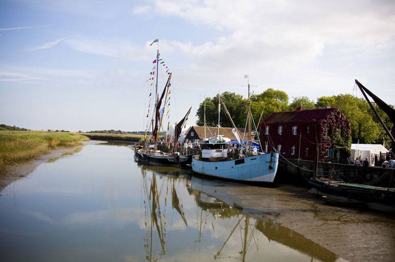 Boats moored on River Alde in Snape Maltings