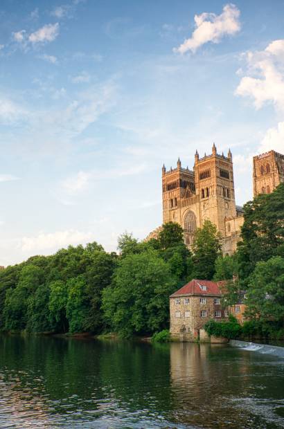 The towers of Durham Cathedral next to a river