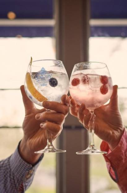 Couple enjoying a day out in Harrogate, North Yorkshire, England, toasting with Gin & Tonics.