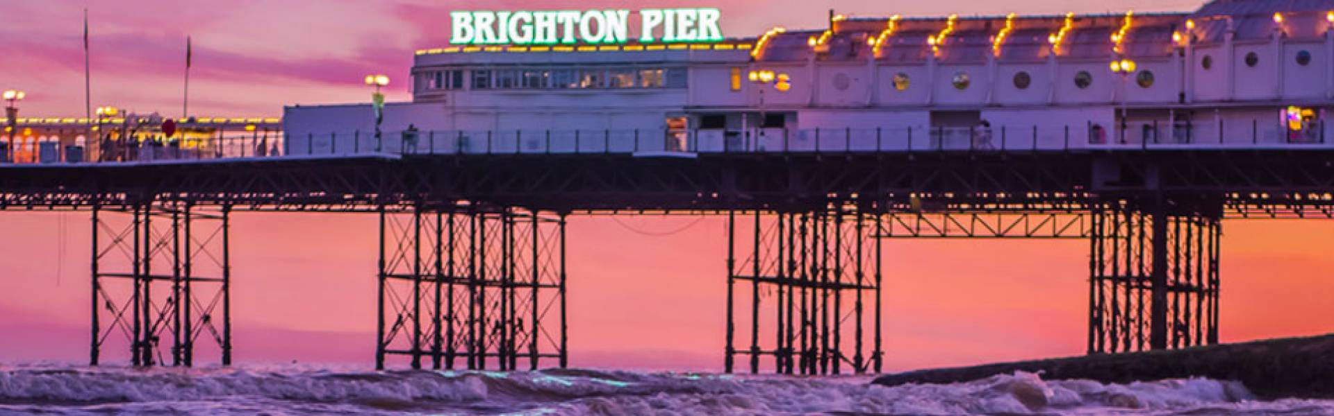 Brighton Pier, Brighton, East Sussex, England at sunset.