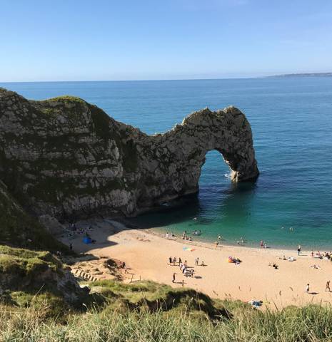 A view of the rock formations and beach at Durdle Door in Dorset