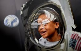 Little girl inside astronaut costume at the National Space Centre