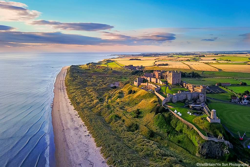 Aerial view of Bamburgh Castle on the coast of Northumberland, England.