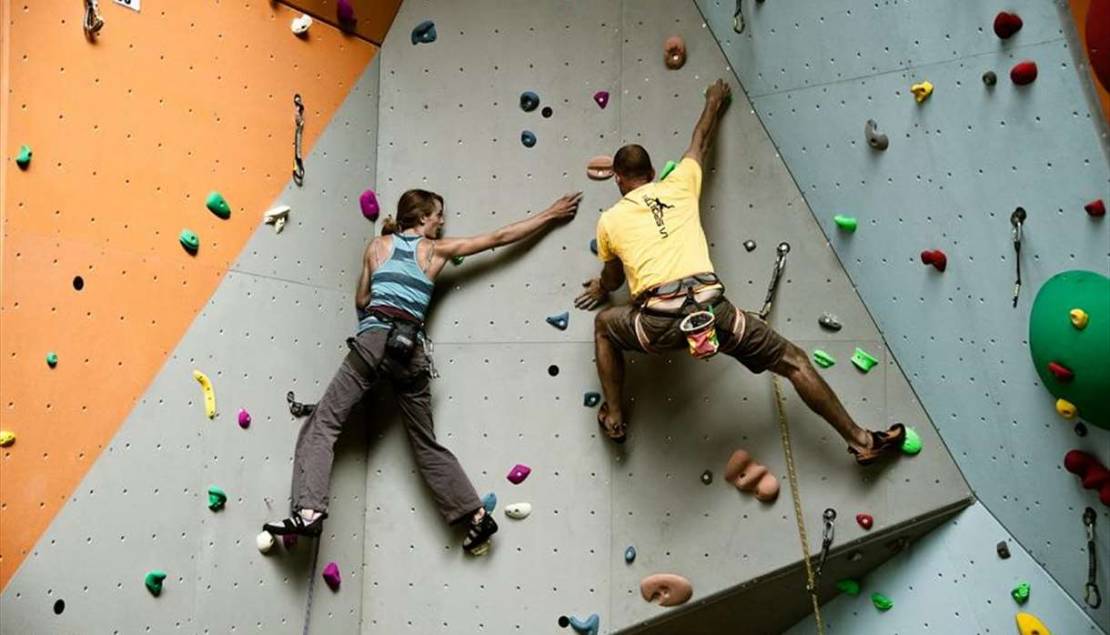 Man and woman on indoor climbing wall