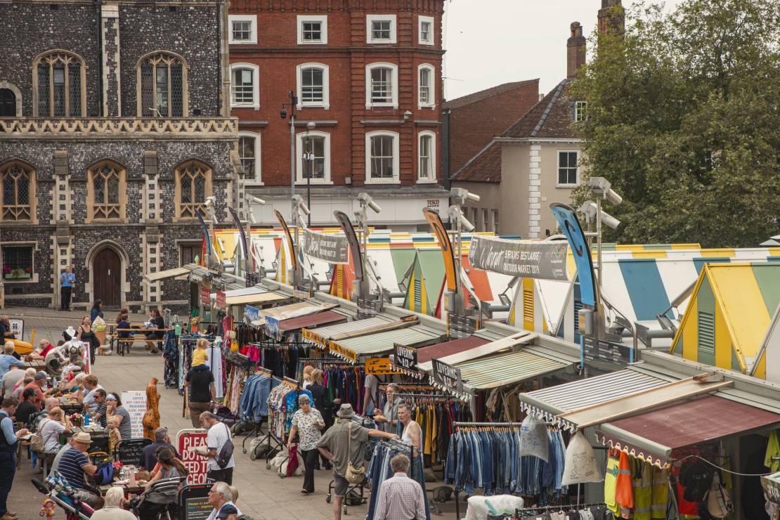 People browsing stalls at Norwich Market