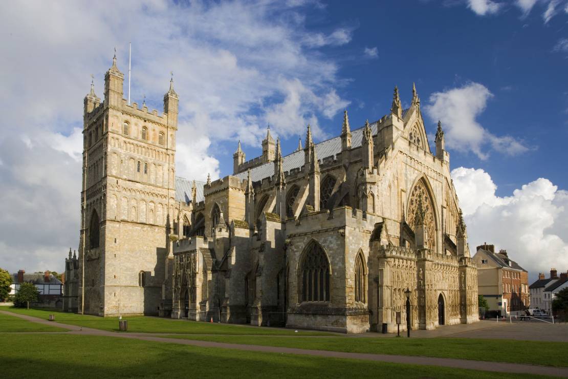 External view of Exeter Cathedral under a cloudy blue sky