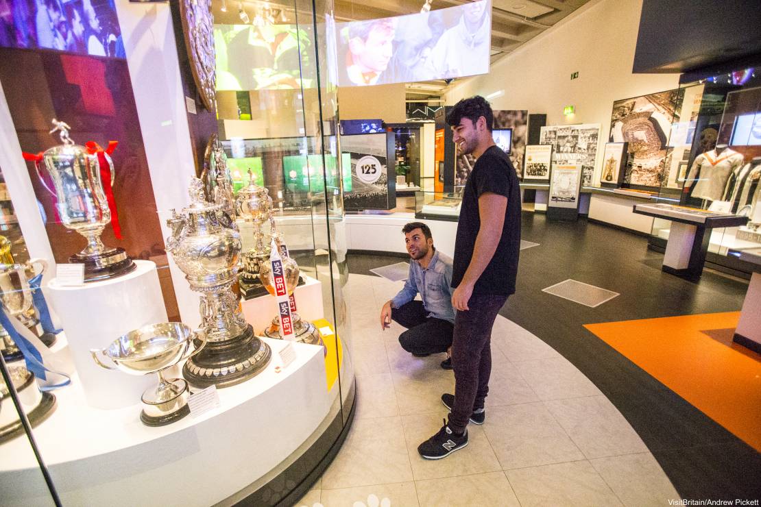 Two men looking at an exhibit in the National Football Museum, Manchester.