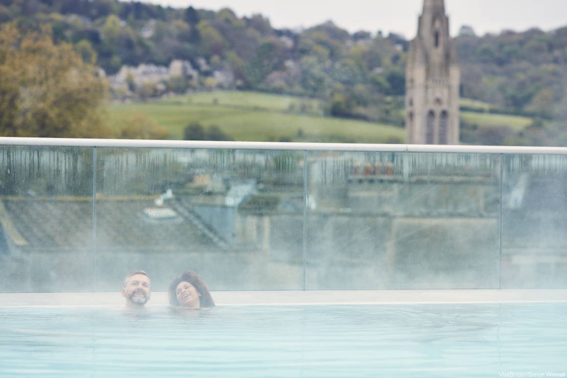 A couple enjoying a dip in the Thermal Spa, Bath, Somerset, England.