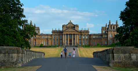 A family walking down a path towards Blenheim Palace, Oxfordshire.