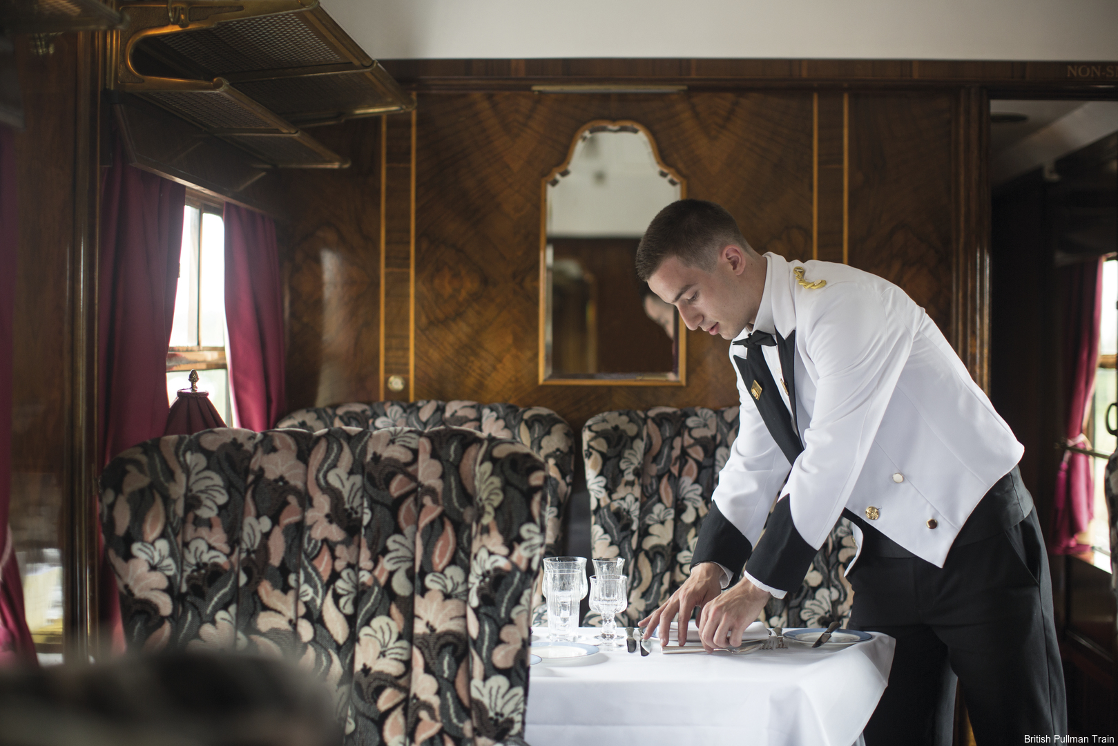 Waiter setting table on Belmond British Pullman
