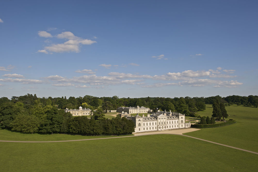 A bird's eye view of Woburn Abbey surrounded by green parkland