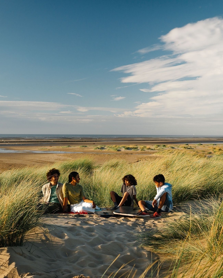 A family enjoy a day out in the sand dunes