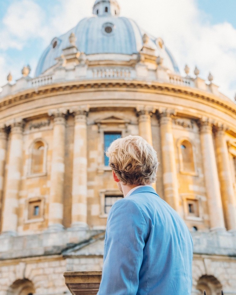 Man looking up at a historical building with dome