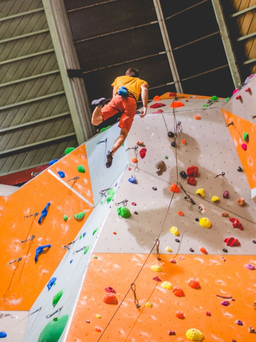 A man climbing up an indoor climbing wall