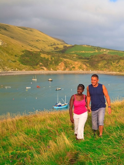 A couple walking on the clifftop.