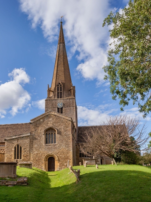 A Parish Church and its tombstones and gardens out the front.