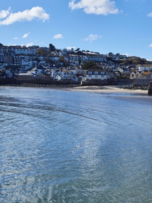 Distant view of sea and harbour with people in orw boats