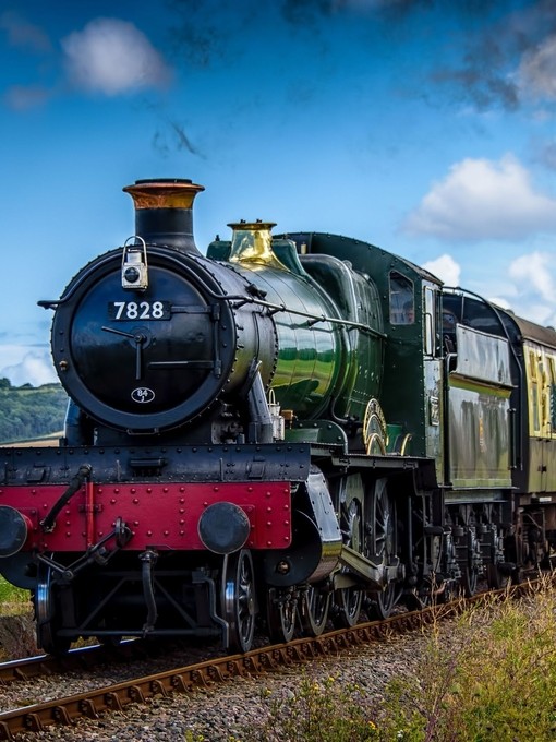 A steam train driving along the coast