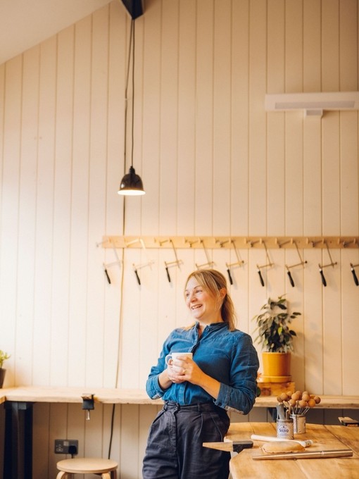Woman sitting in a workshop at jewellery making class