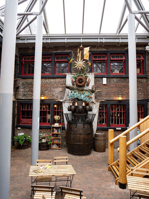 Chairs, tables and a sculpture at an internal courtyard