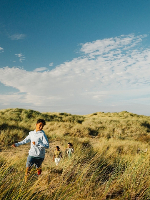 A family enjoy a day out in the sand dunes