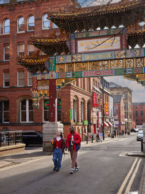 Two people chatting, exploring a local Chinatown district.