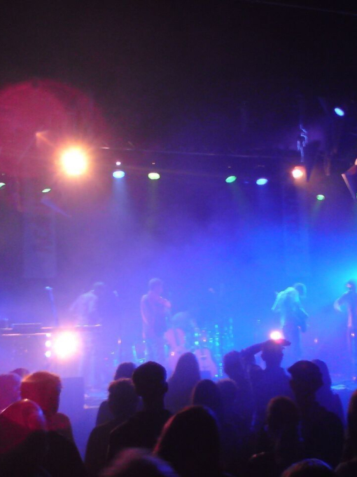 A band performing on stage at concert venue