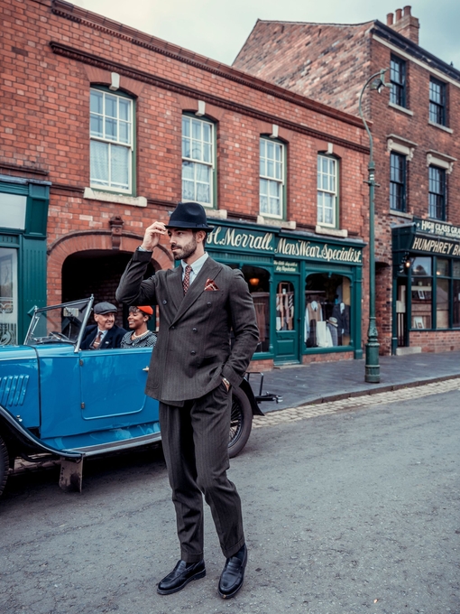 A man dressed in period costume visits a living museum