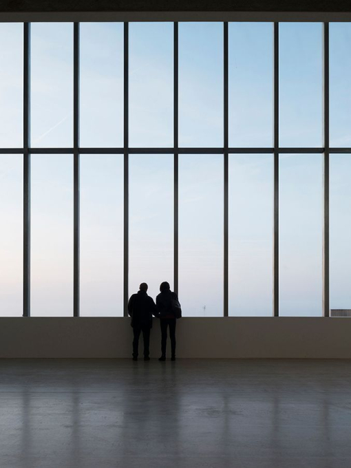 Two people looking out of a large window, Turner Contemporary