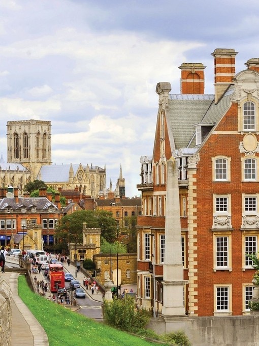 View of the red brick exterior of The Grand Hotel York with the city wall