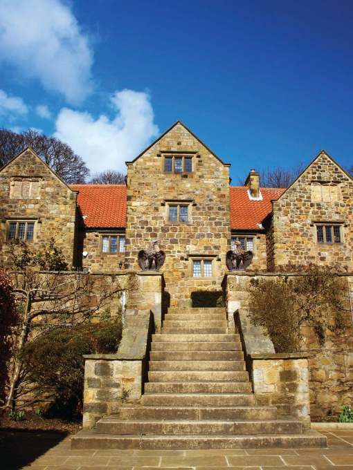Main stone walkway and grand entrance to an old town hall.