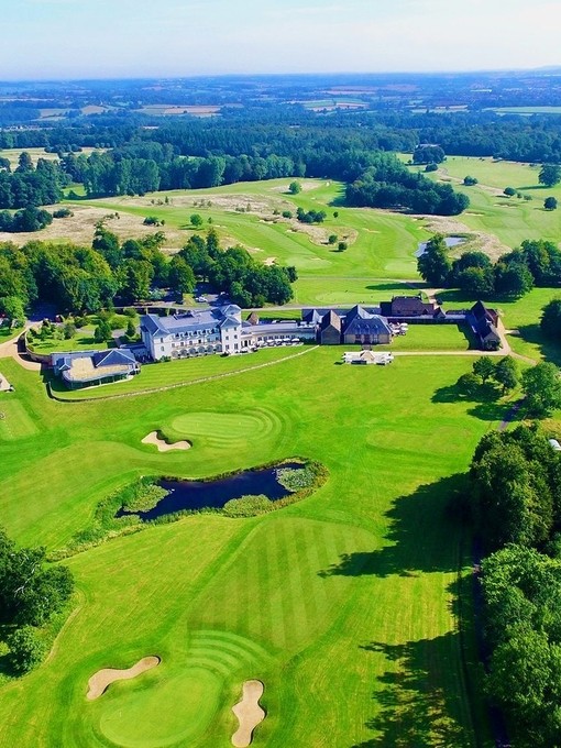 An aerial photo of a large hotel and other buildings surrounded by a golf course. Bowood Hotel, Spa and Golf Resort - Silver award winner for Large Hotel of the Year at the VisitEngland Awards for Excellence 2023.