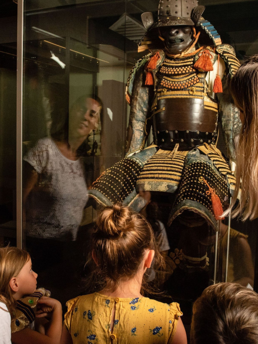 A group of people looking at a historic exhibition