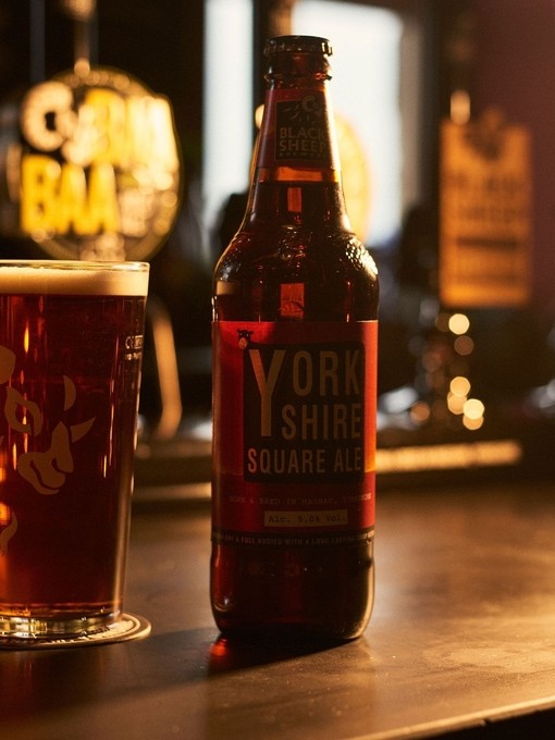 Close up of selection of beers on wooden shelf