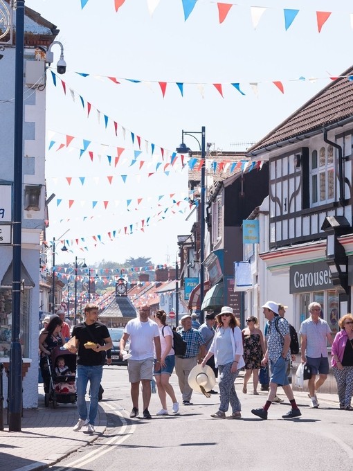 Groups of people walking down a shopping street in Sheringham
