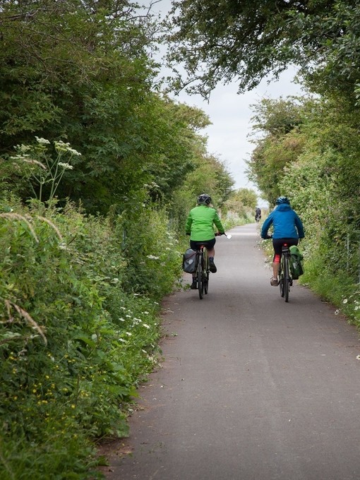 People cycling through the countryside