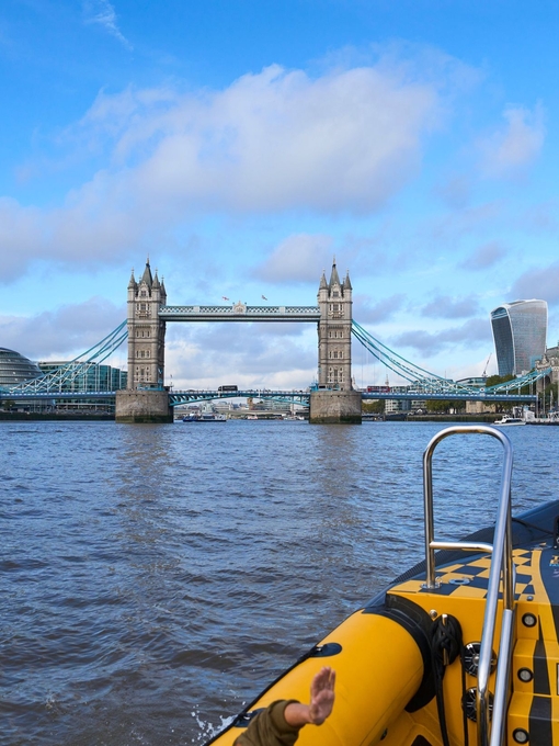 Group of people on board a speed boat on a city river