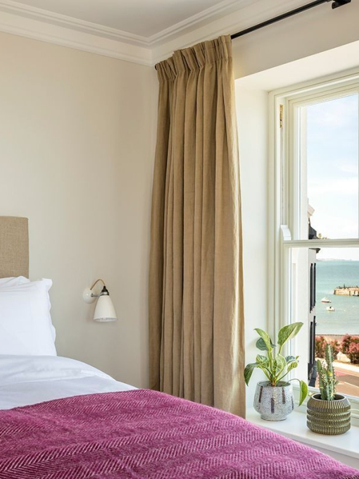 The ocean view of a room in a boutique hotel in a seaside town.