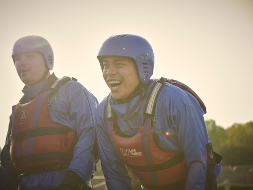 Teenagers standing and laughing wearing protective clothing