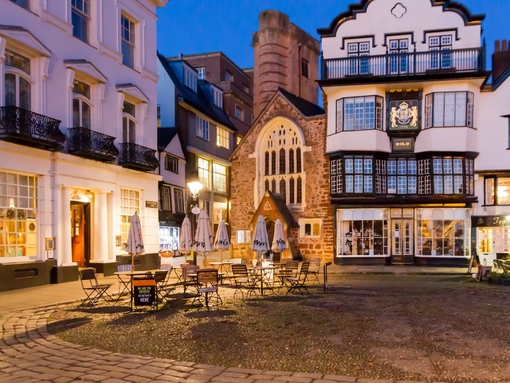 A quaint English town square in the evening.