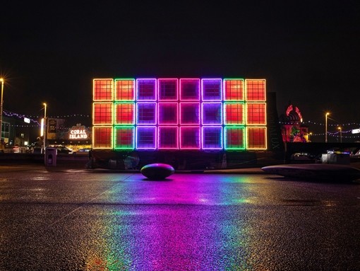 A colourful light installation at night.