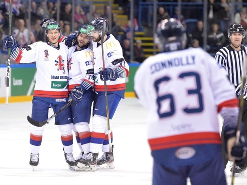 Men celebrating after scoring at ice hockey game