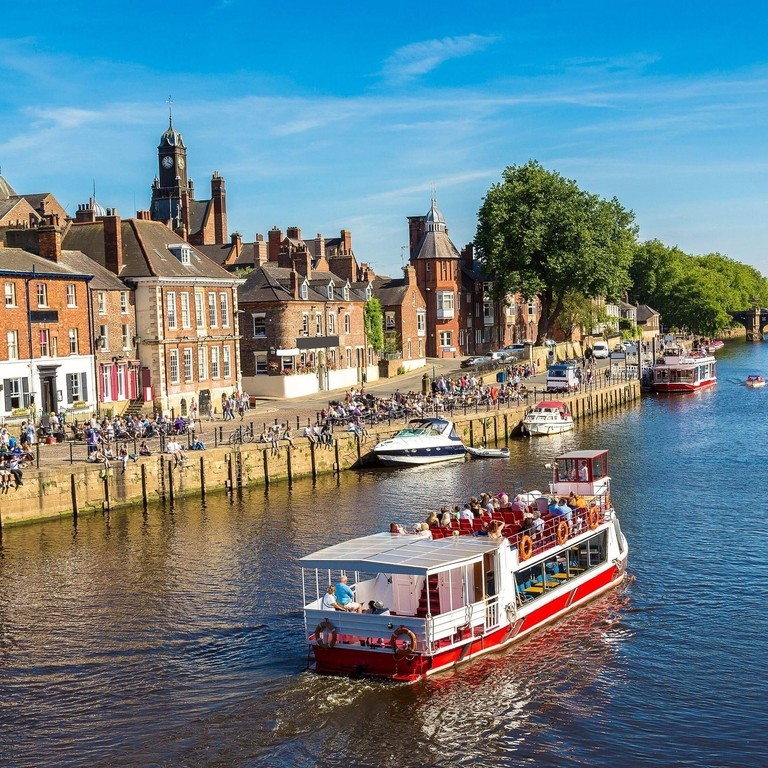 A cruise ship travelling down the River Ouse in York
